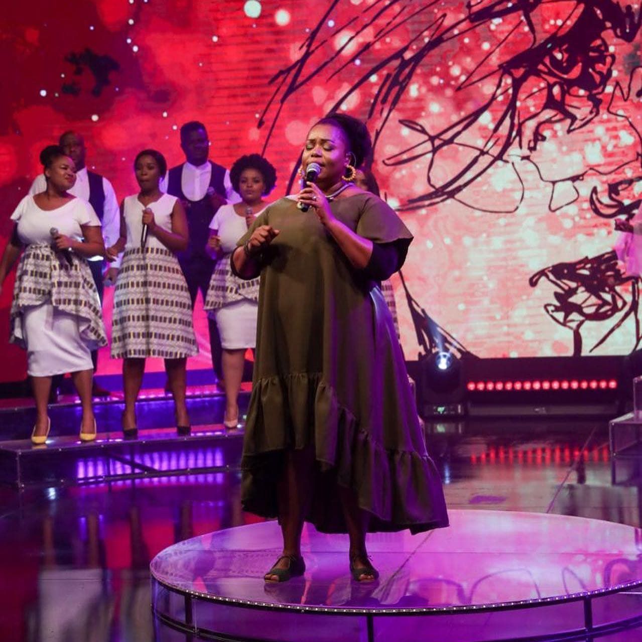  Chevelle singing on stage with a choir. 