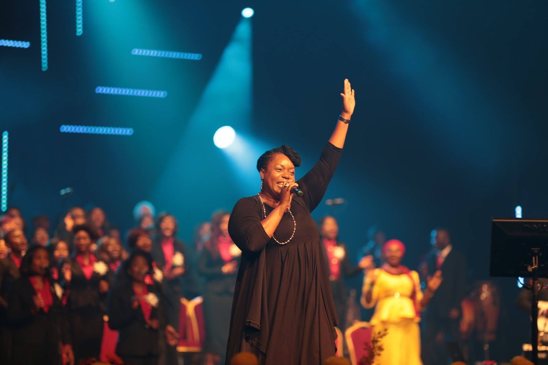  Chevelle, arm raised, singing into a microphone. 