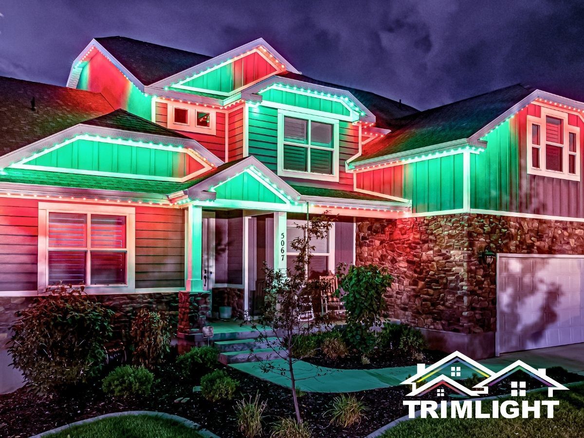 House decorated with red and green lights for the holidays.
