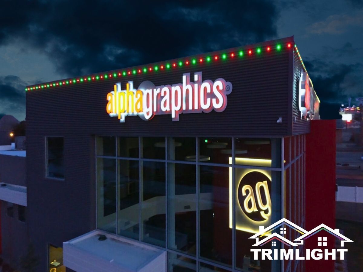 AlphaGraphics building at night with red and green lights. 