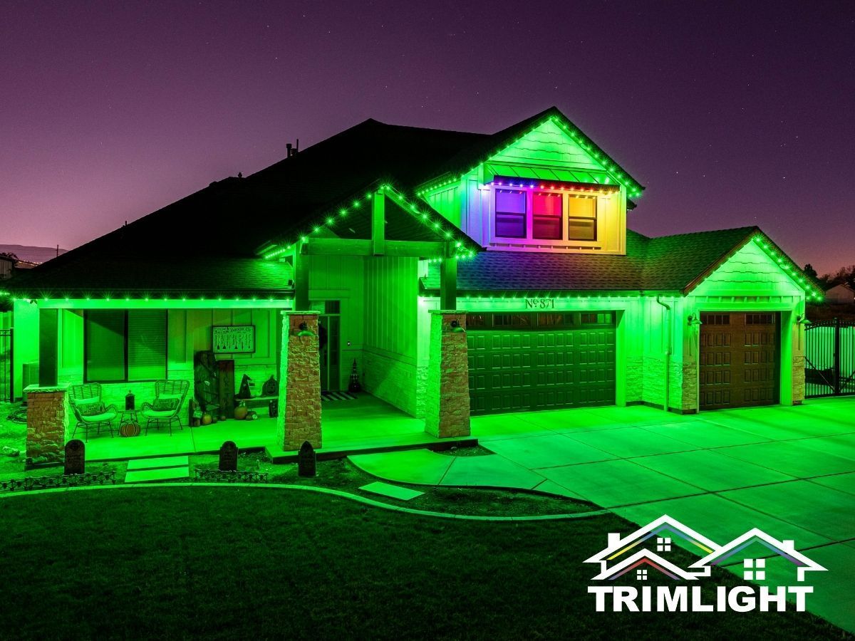Green and purple lit house at night with Trimlight logo.