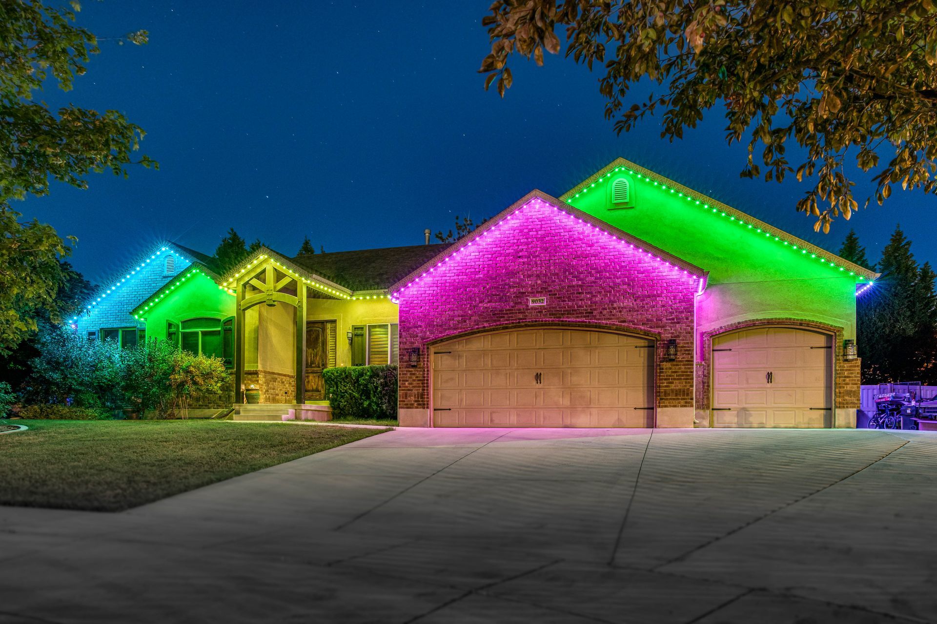 House at night decorated with colorful Christmas lights.