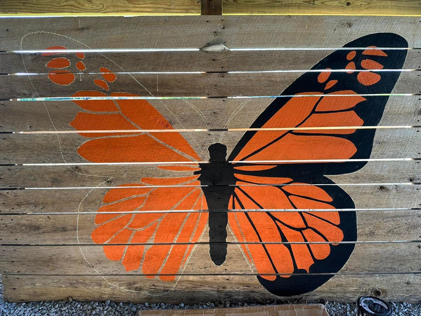 Orange and black butterfly painted on a wooded barn door at Country Pumpkins in Dry Ridge, KY