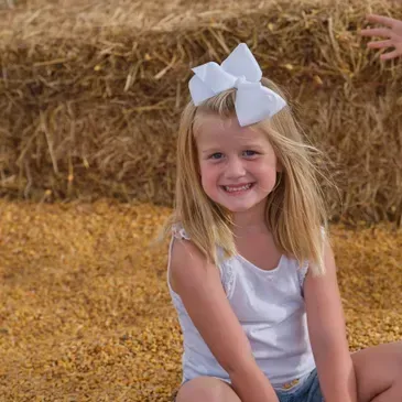 Smiling Girl With a White Ribbon on Her Head — Dry Ridge, KY — Country Pumpkins