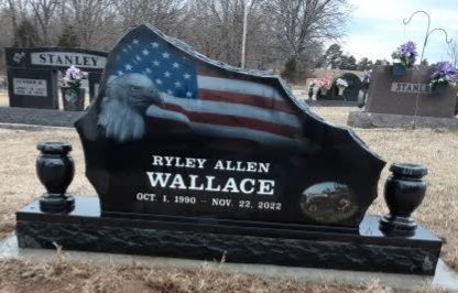 Black tombstone with painted landscape, names Ringeisen, dates Sept. 6, 1946 - Mar. 7, 2007 and Apr. 28, 1948.