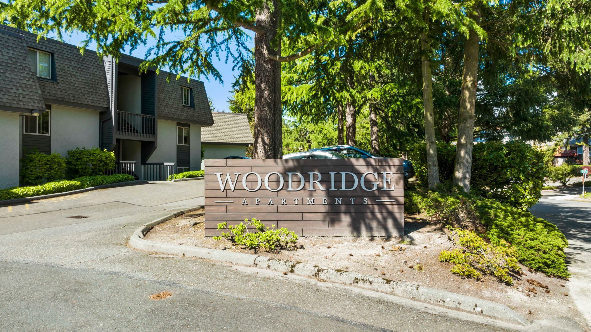 a woodbridge apartment building with a sign in front of it