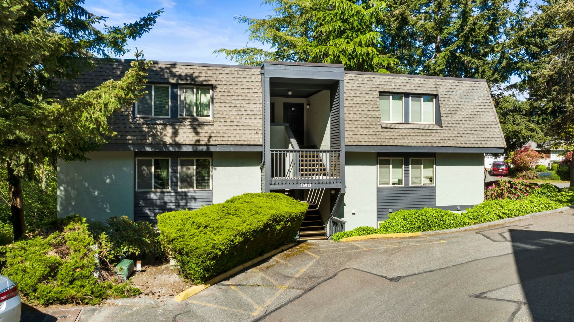 a house with a car parked in front of it .