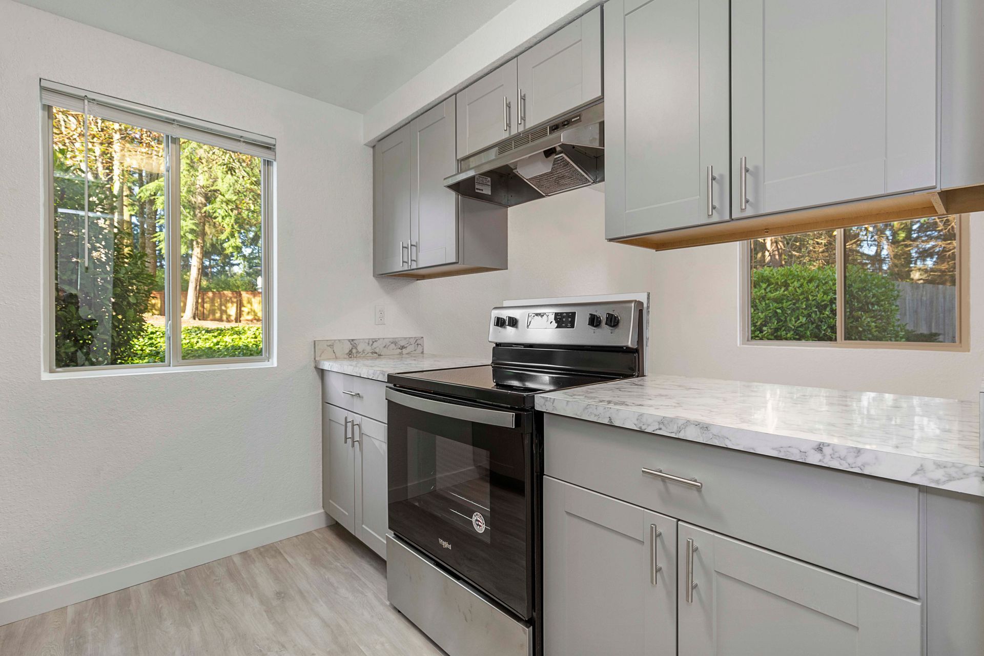 a kitchen with stainless steel appliances and white cabinets