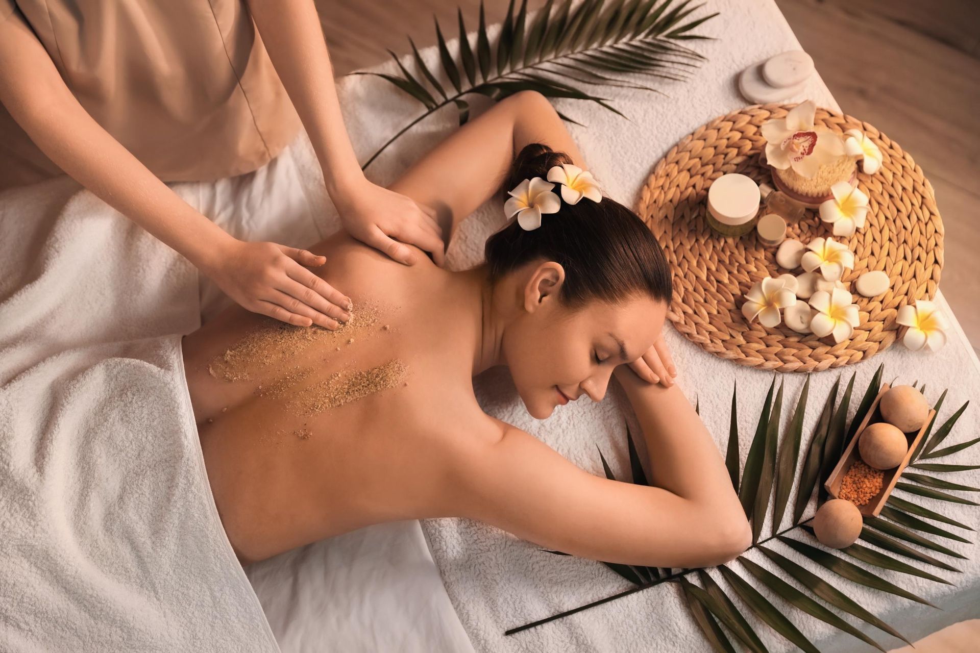 Woman receiving a back scrub at a spa. 