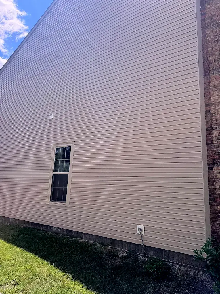 A large house with a window on the side of it.