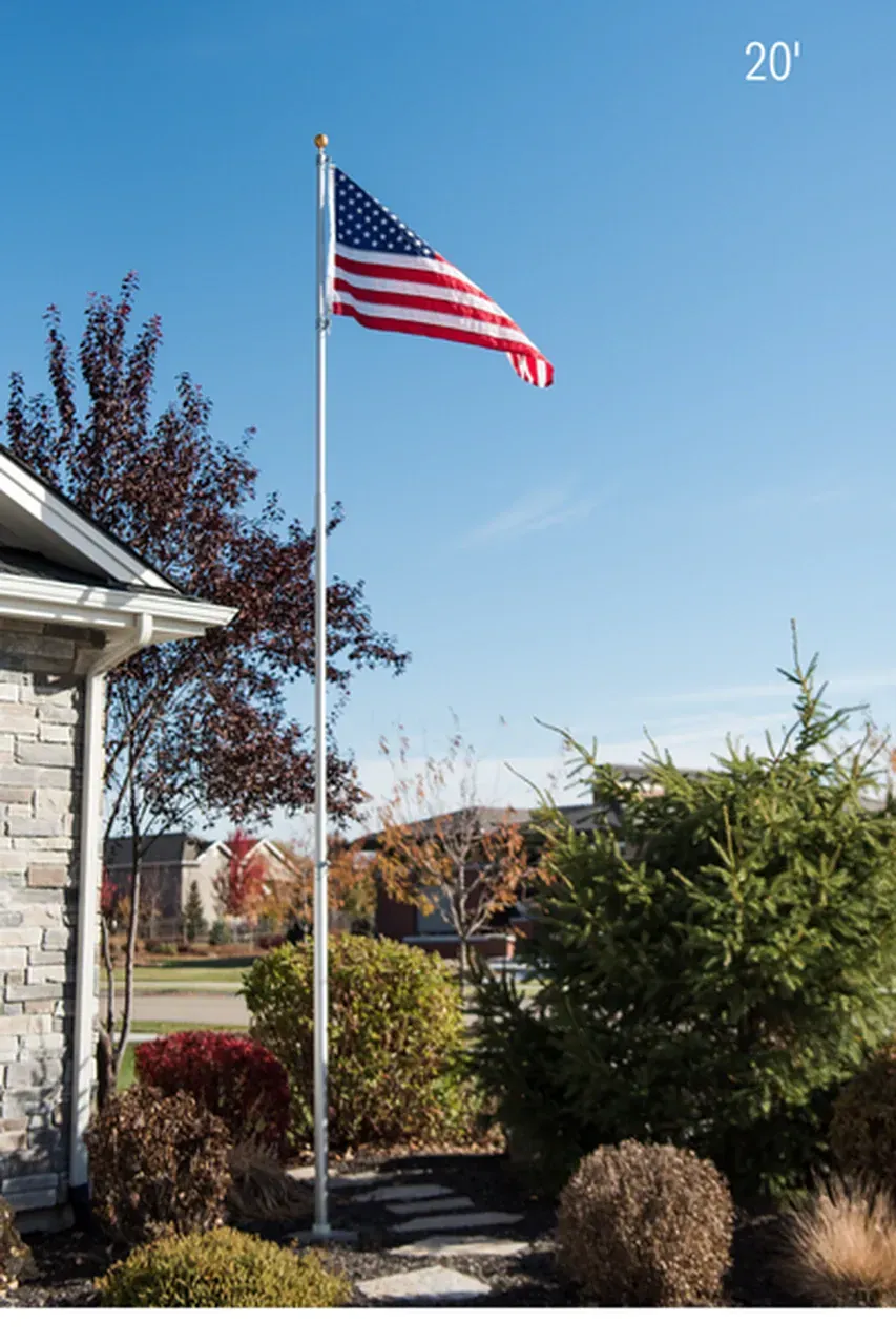 An american flag is flying in front of a house.