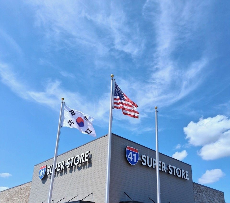A large 41 Superstore building with three flagpoles in front