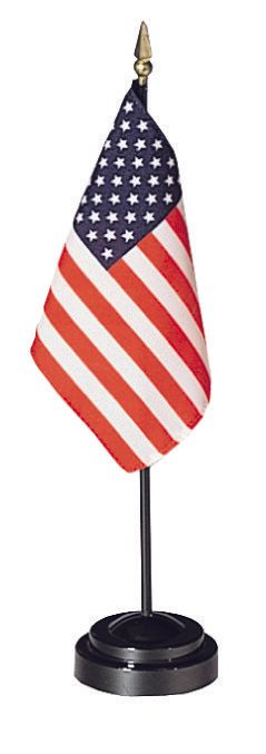 A small american flag on a black stand on a white background