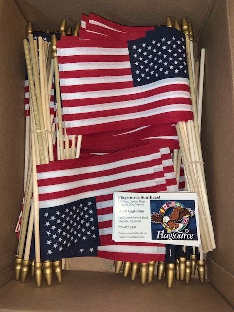 A box filled with american flags and a card that says ' freedom ' on it