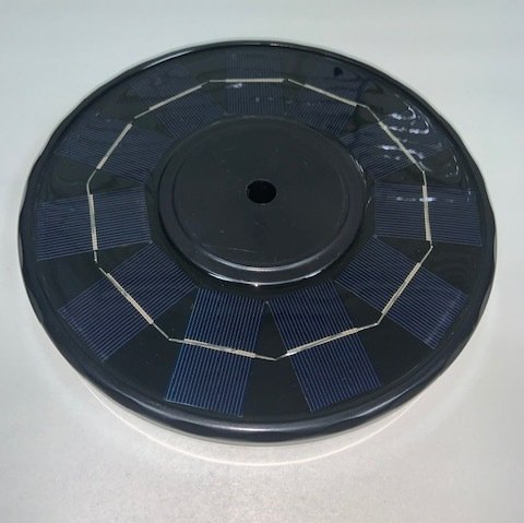 A black disc with a hole in the middle of it