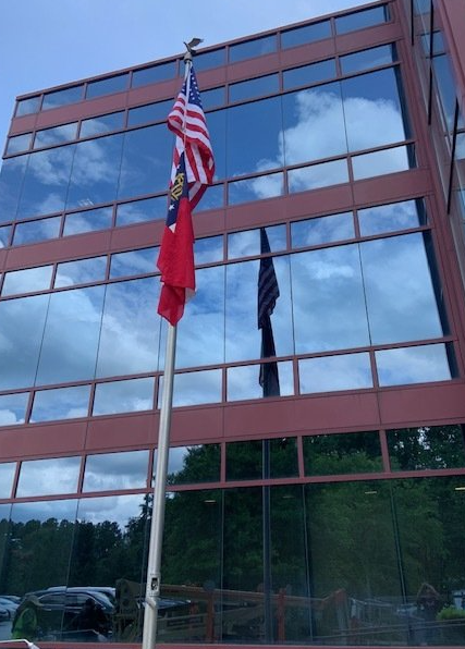An american flag is flying in front of a building