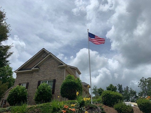 An american flag is flying in front of a house