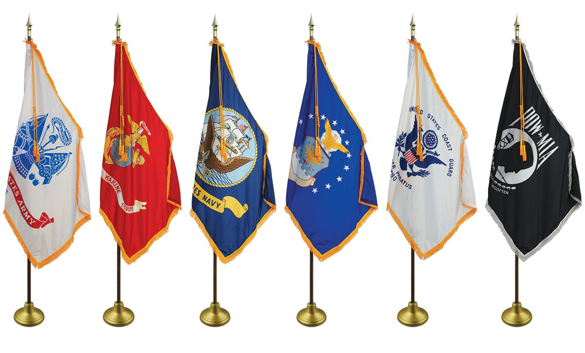 A group of flags are lined up in a row on stands.