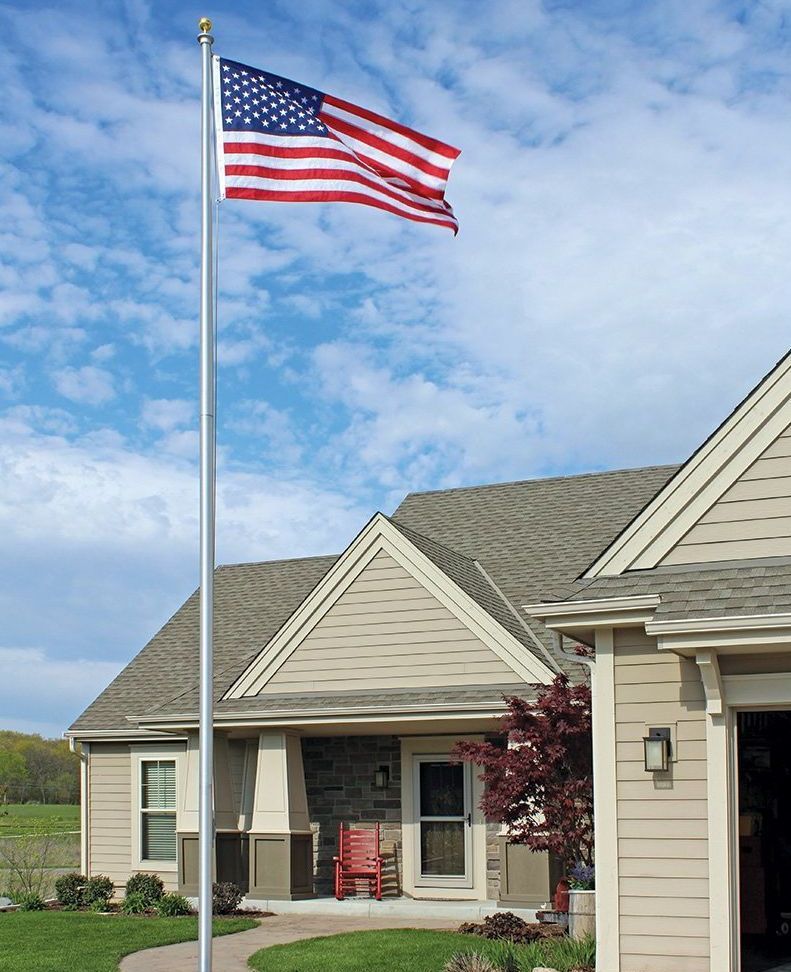 An american flag is flying in front of a house