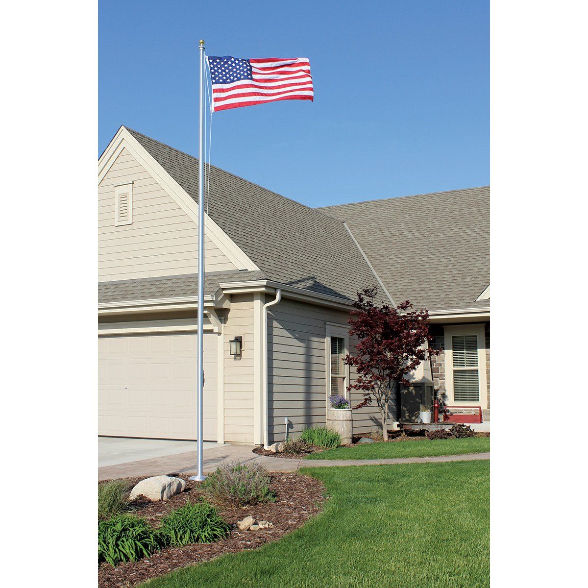 An american flag is flying in front of a house