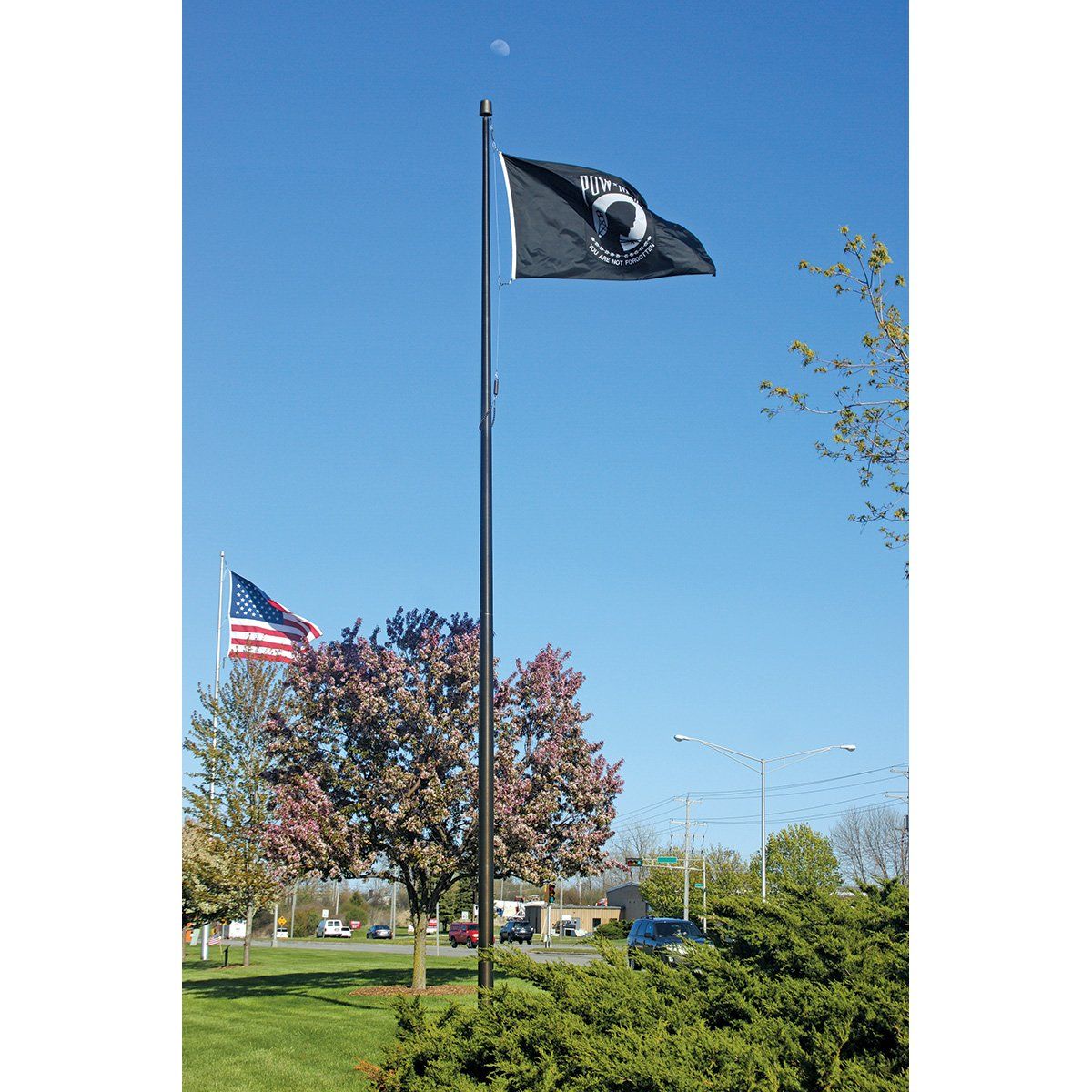 A black flag is flying on top of a flag pole