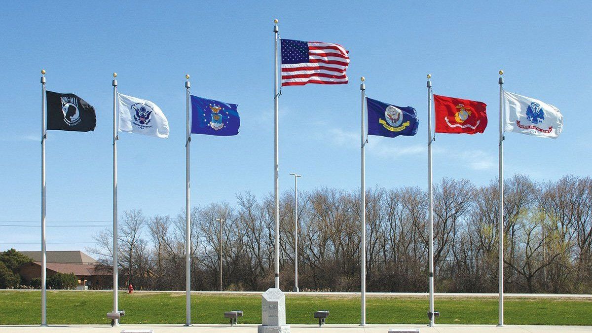A row of flags are flying in the wind