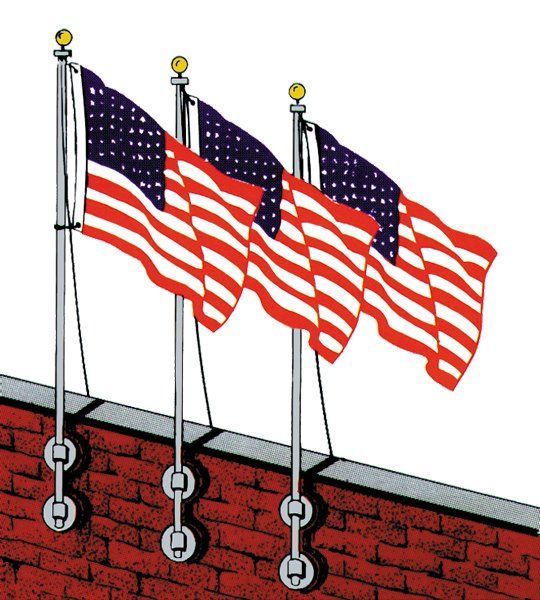 Three american flags are hanging on a brick wall