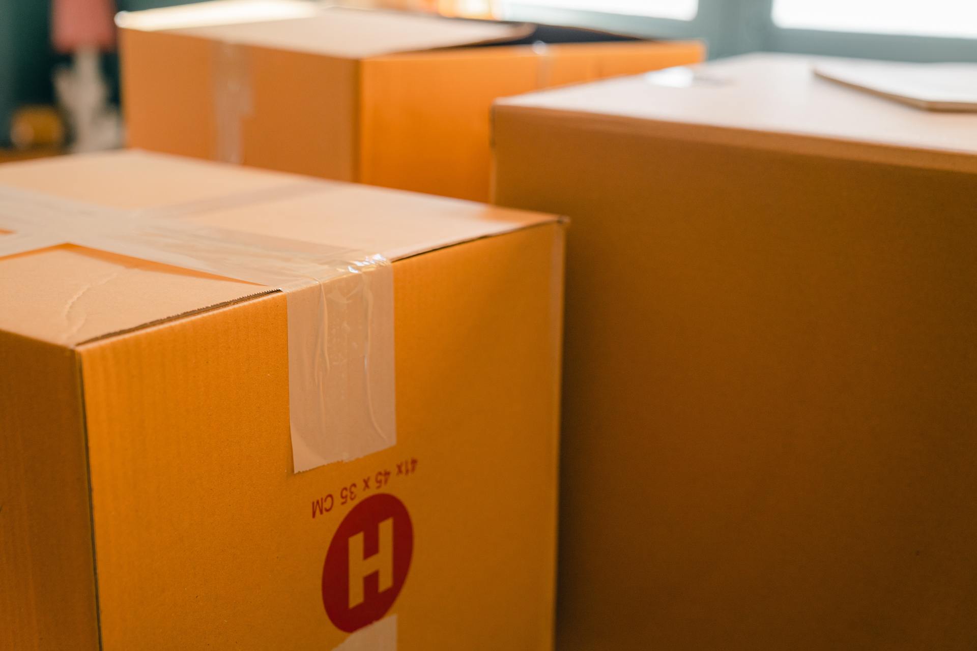A row of cardboard boxes are sitting on top of each other on a table.