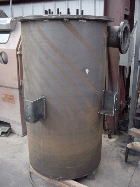 A large metal cylinder is sitting on the ground