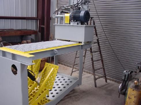 A machine is sitting in a room next to a ladder.