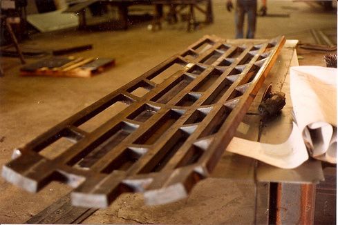 A large piece of metal is sitting on a table in a factory.