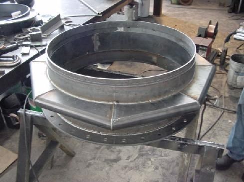 A large metal ring is sitting on top of a wooden table.