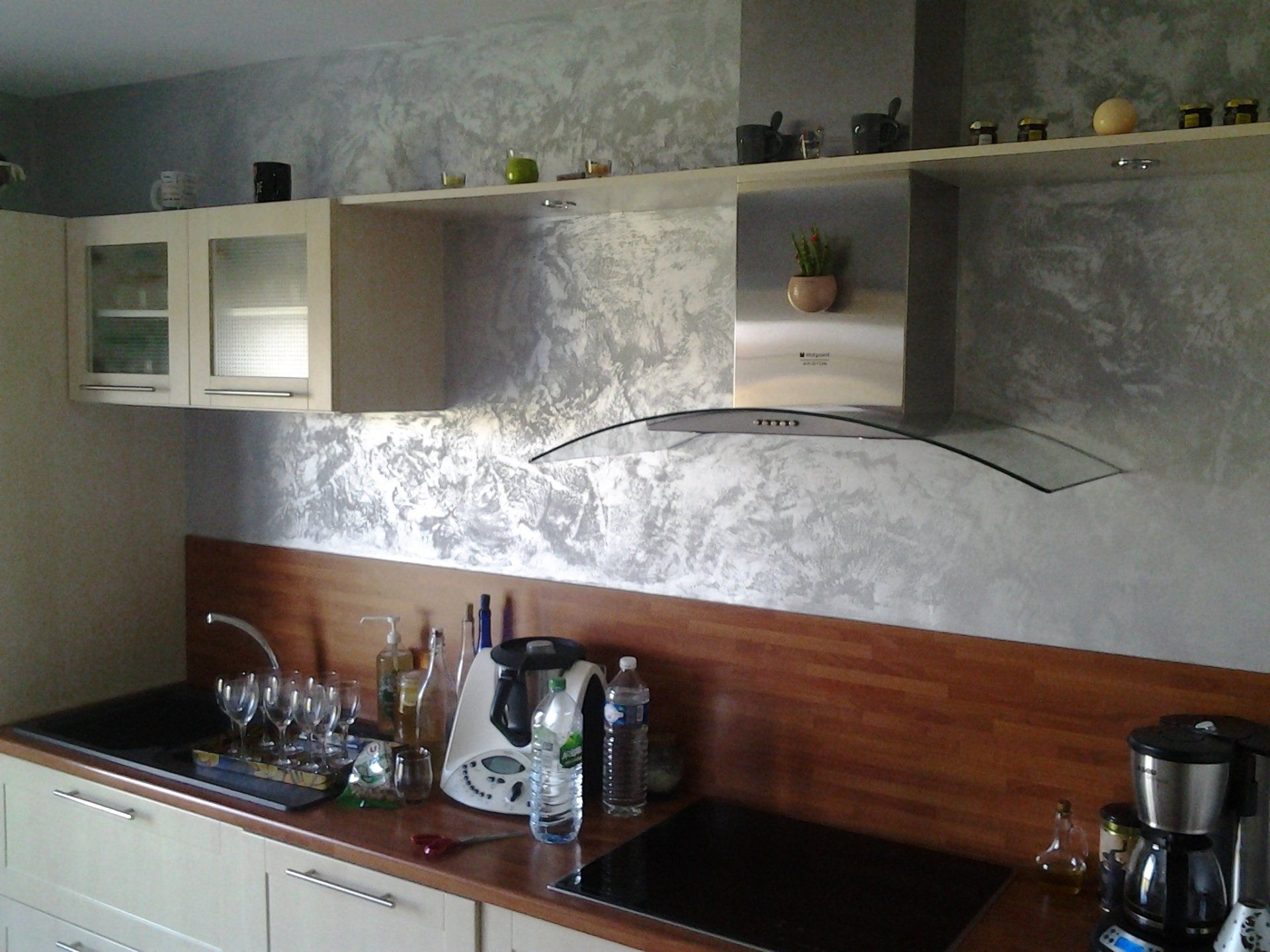 Une cuisine avec des armoires blanches et un four sur cuisinière