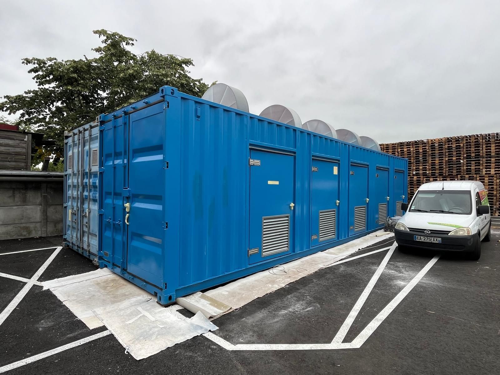 Un conteneur maritime bleu, muni de plusieurs portes et aérations