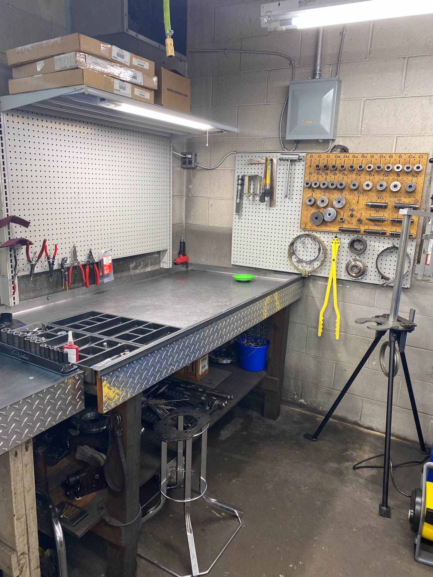 A workbench with a lot of tools on it in a garage.