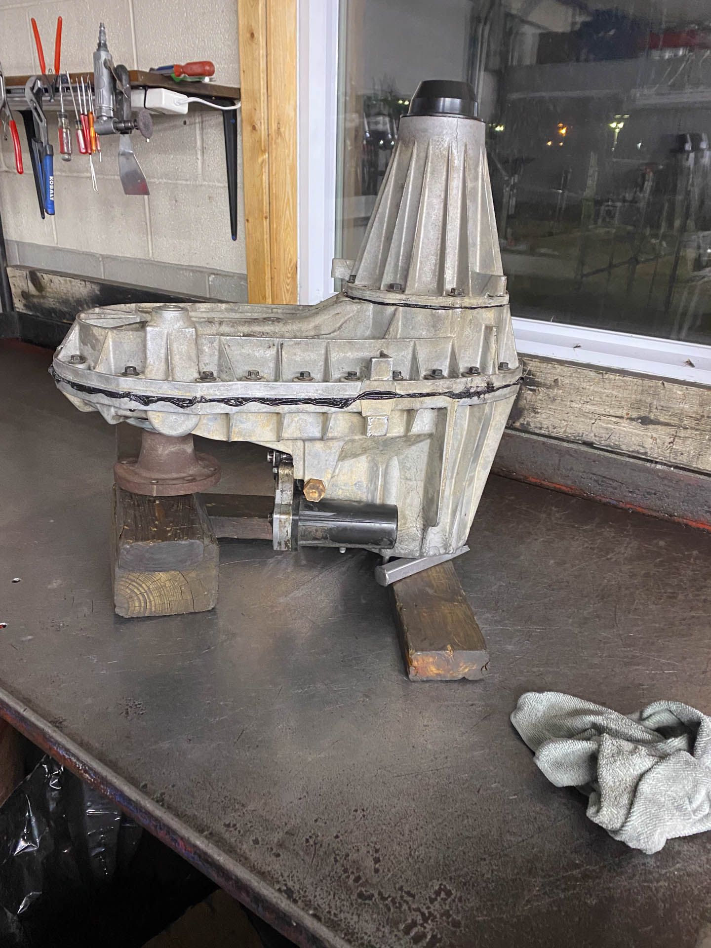 A large piece of metal is sitting on top of a metal table.