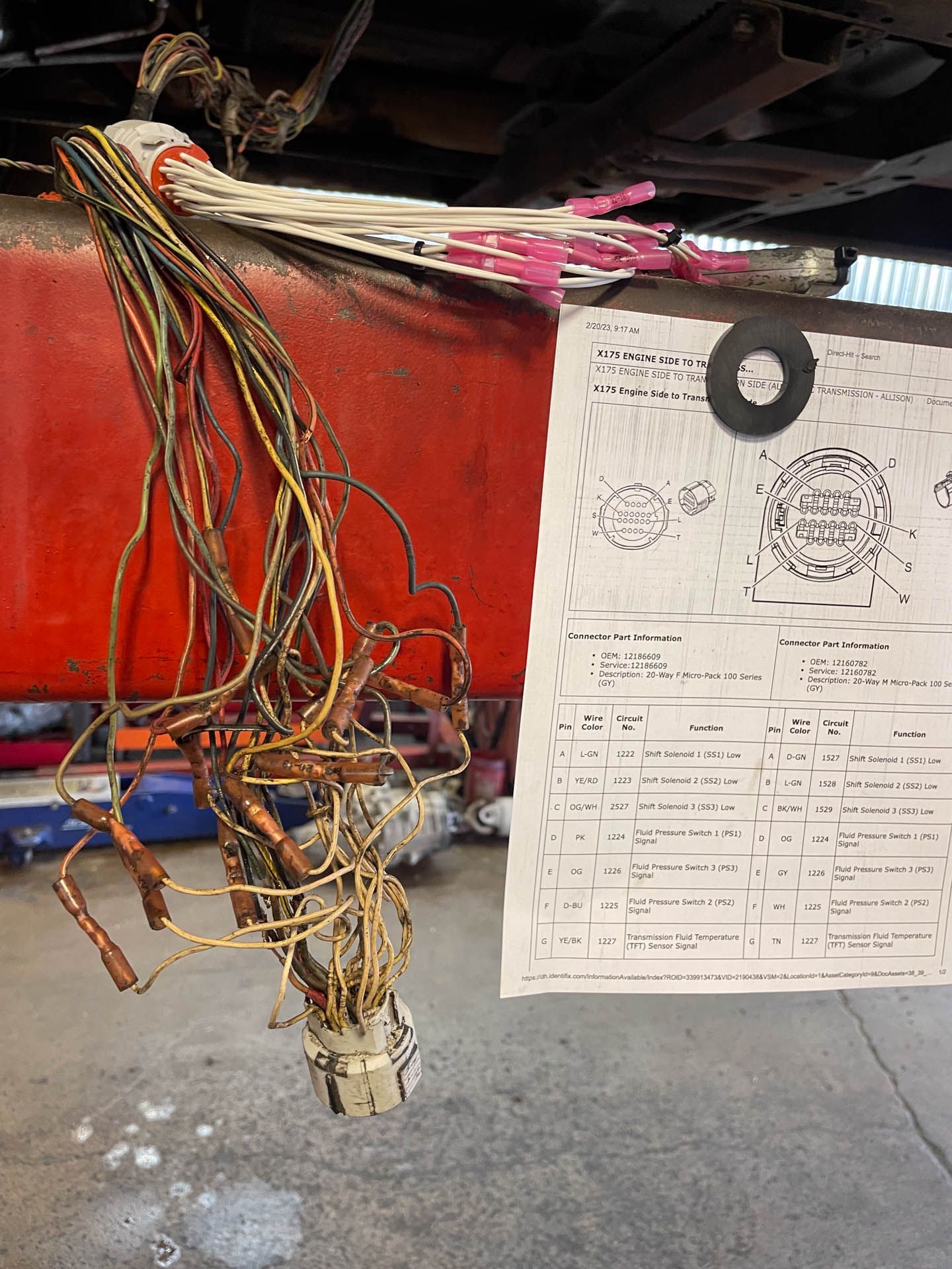 A bunch of wires are hanging from a piece of paper