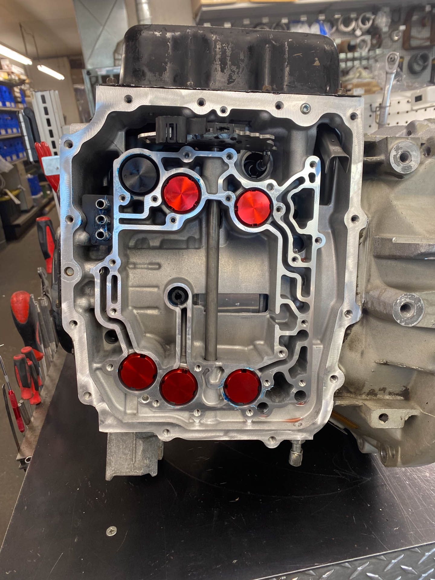 A close up of a car engine with red circles on it.