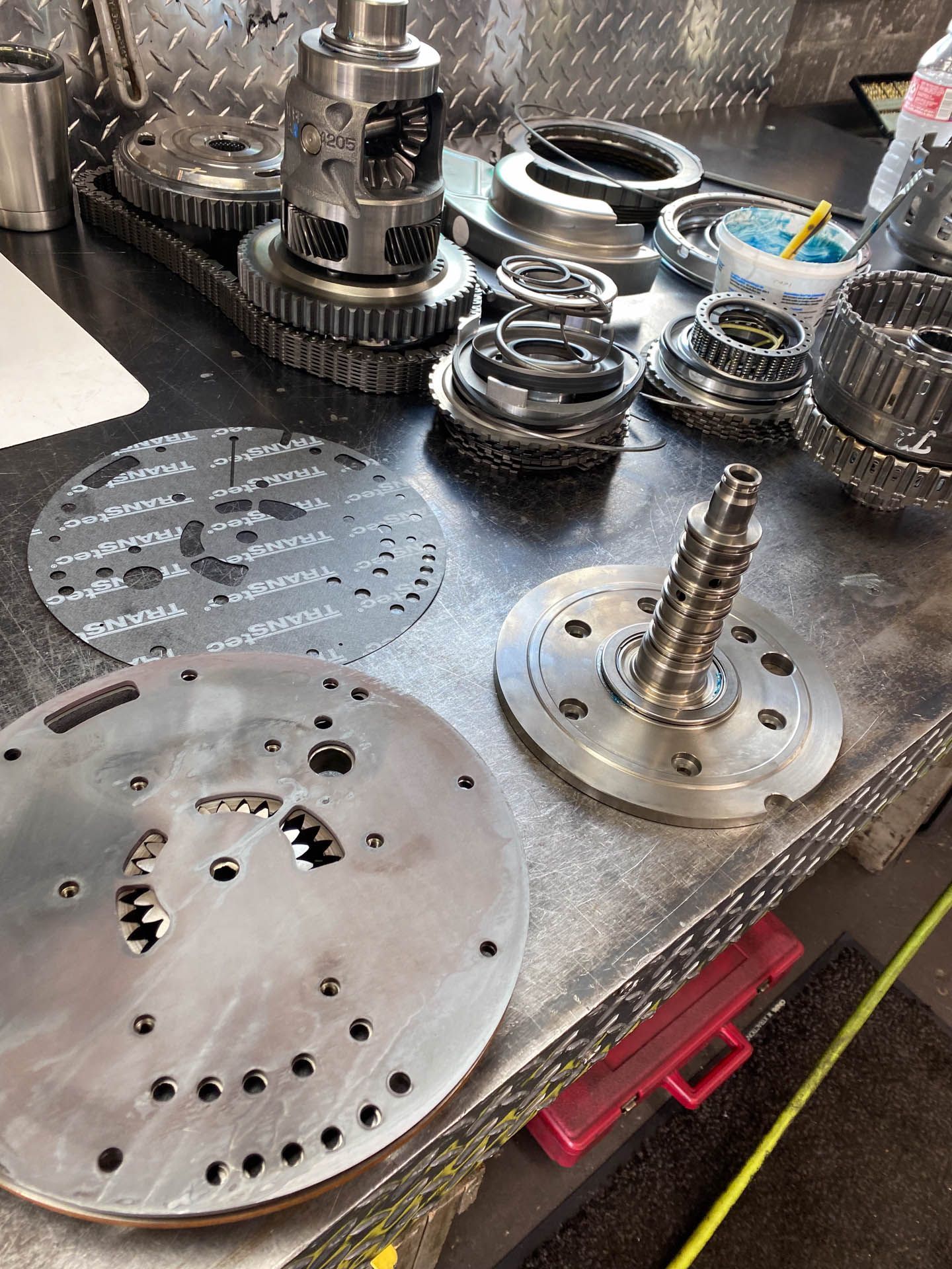 A bunch of metal parts are sitting on a table.