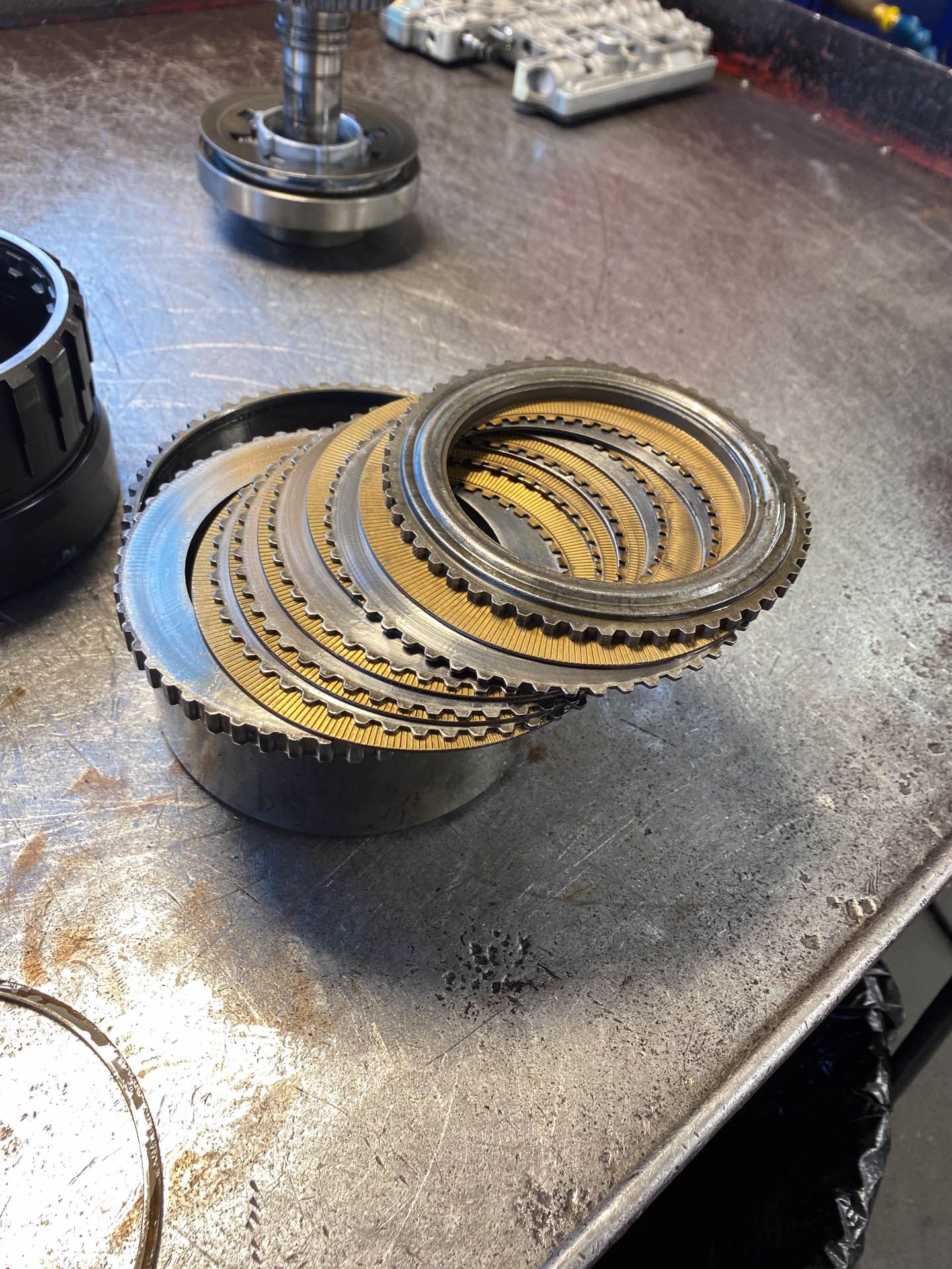 A bunch of gears are stacked on top of each other on a table.