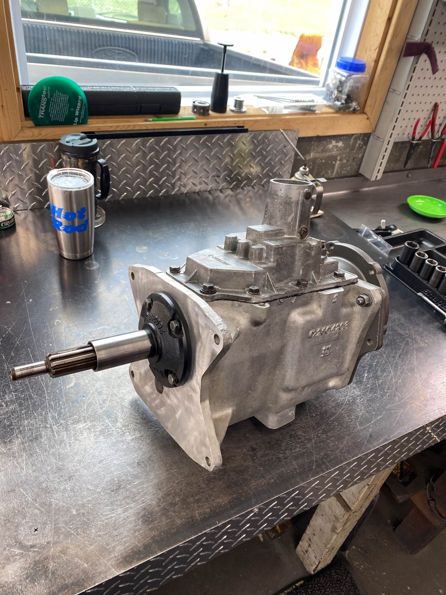 A gearbox is sitting on a table next to a window.