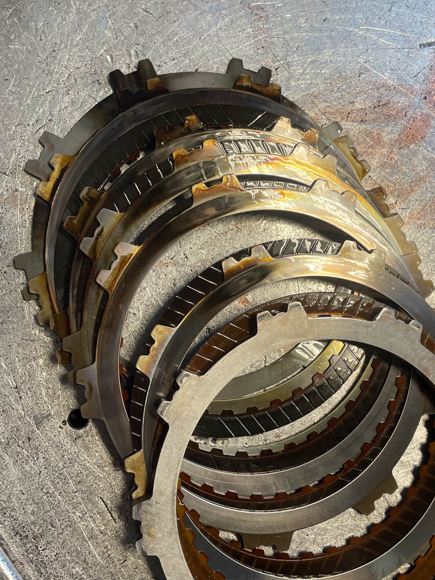 A bunch of clutch plates are stacked on top of each other on a table.