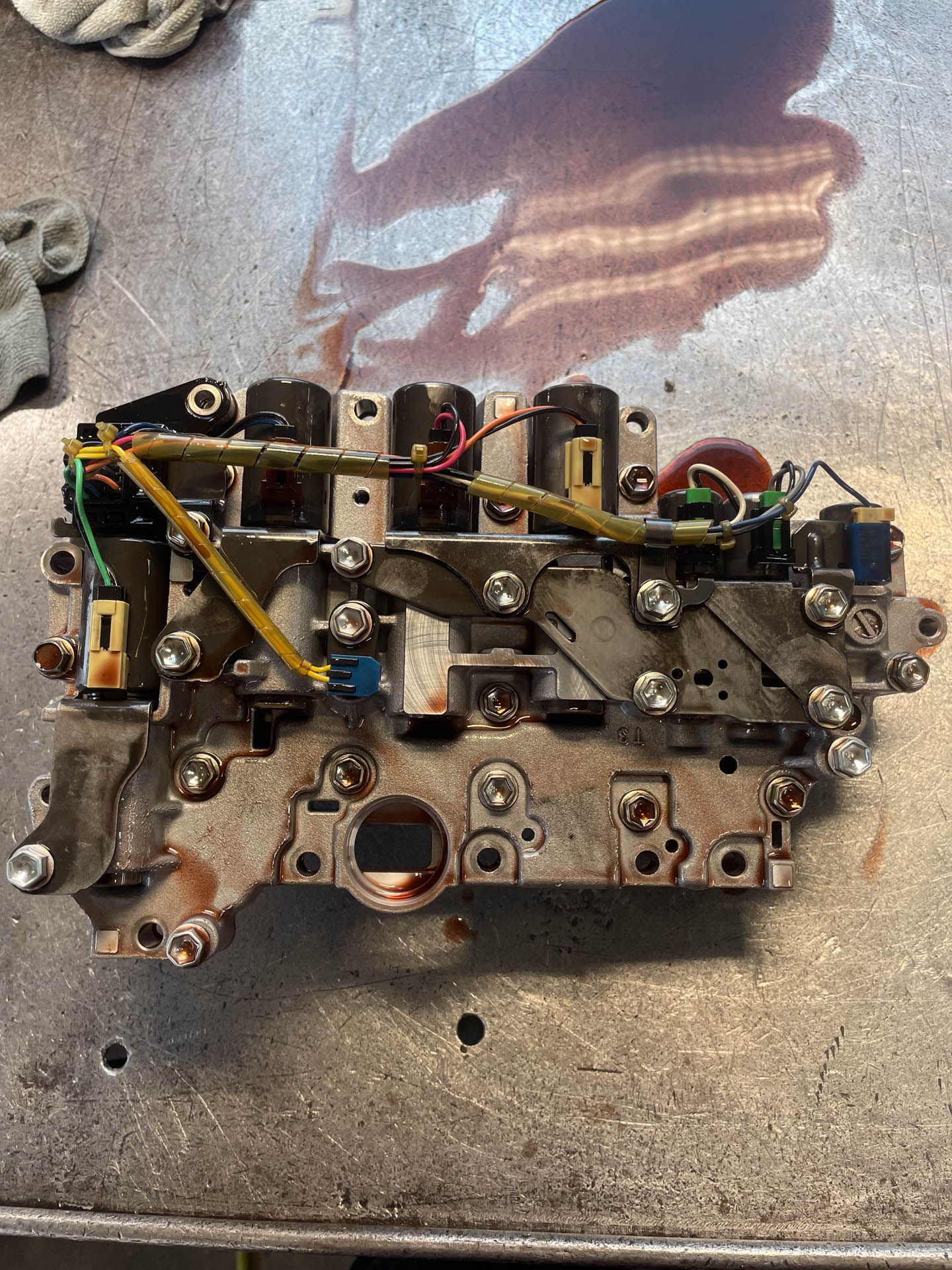 A piece of metal is sitting on top of a metal table.