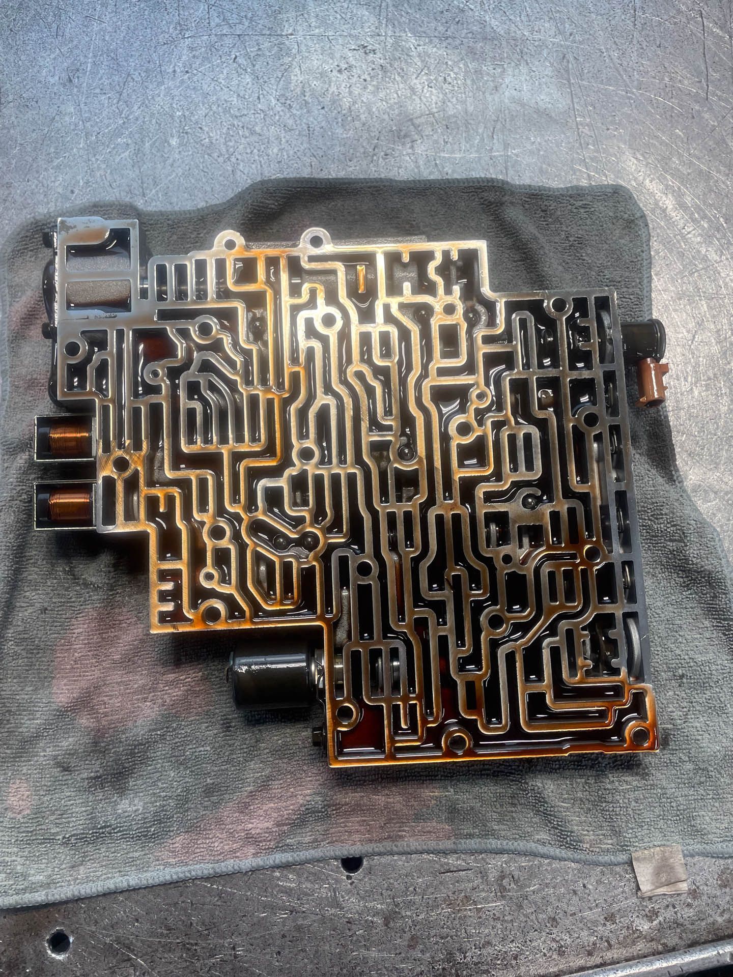 A piece of metal that looks like a maze is sitting on a table.