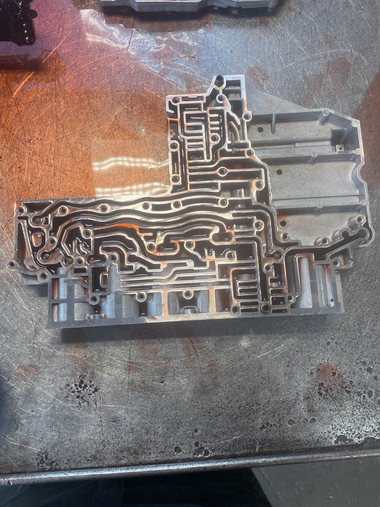 A piece of metal that looks like a maze on a table
