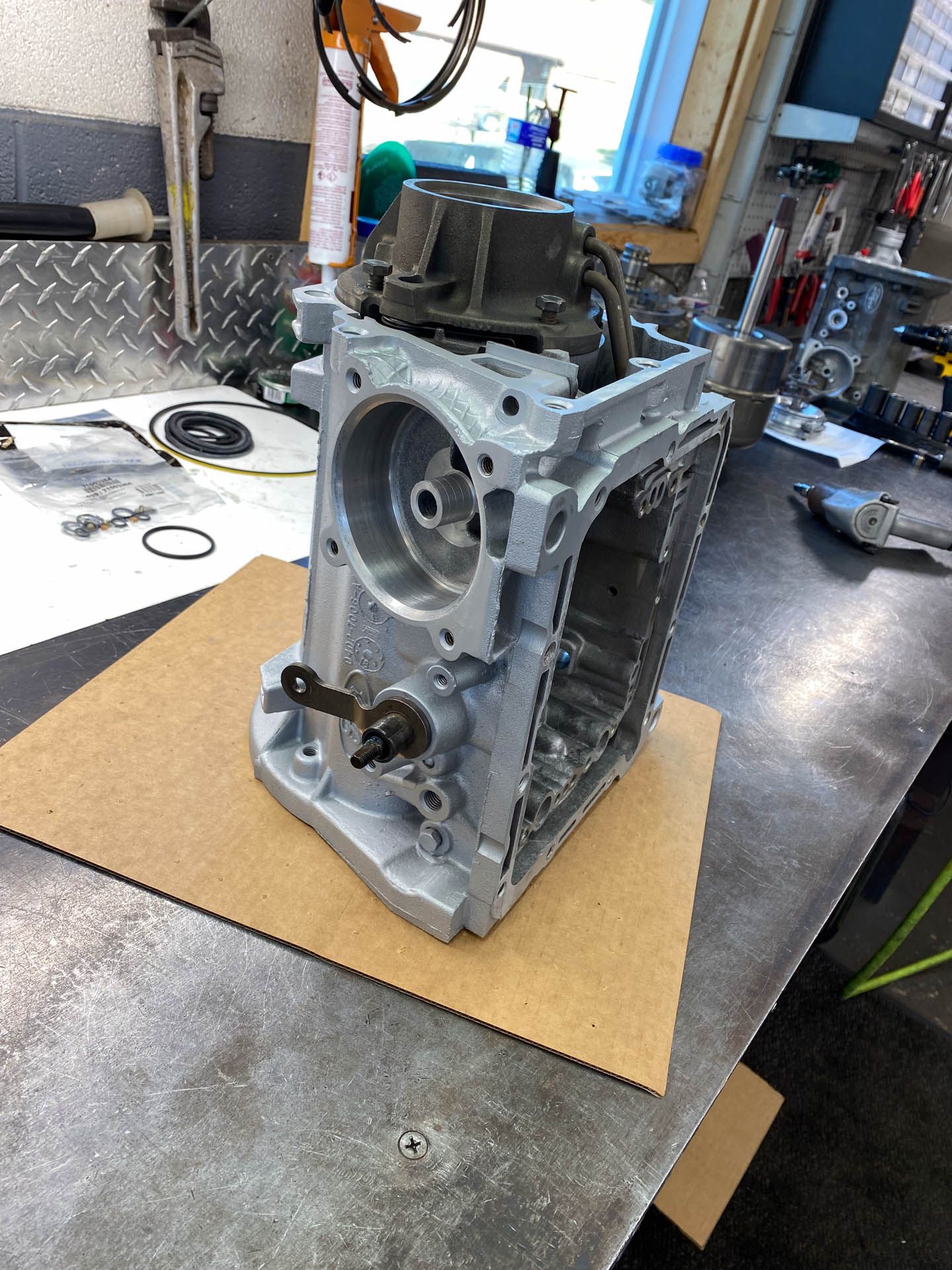 A piece of metal is sitting on a piece of cardboard on a table.