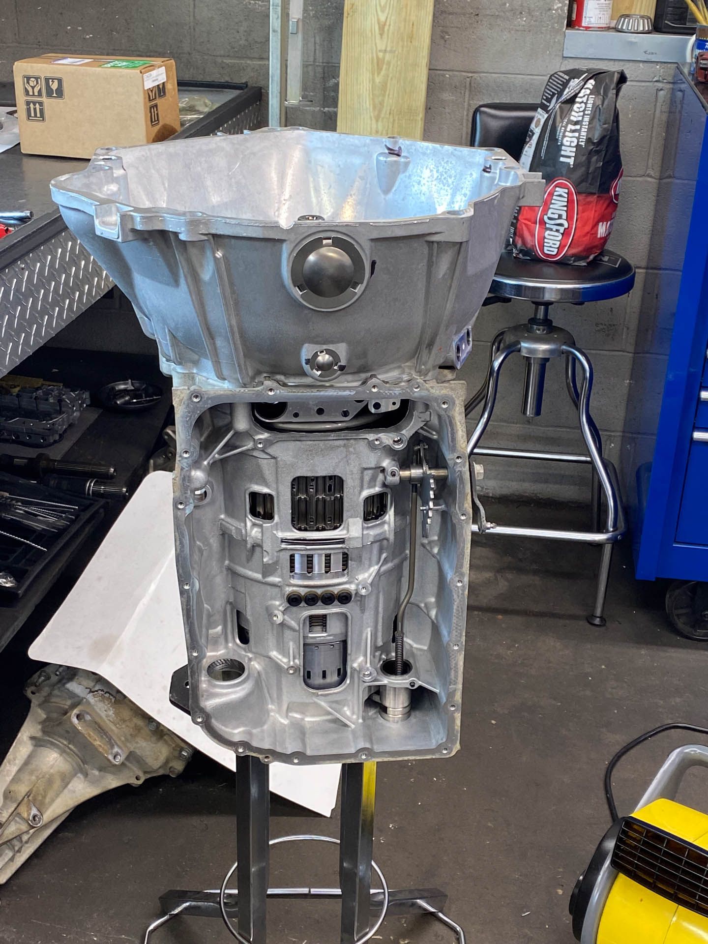 A large metal object is sitting on top of a metal stand in a garage.