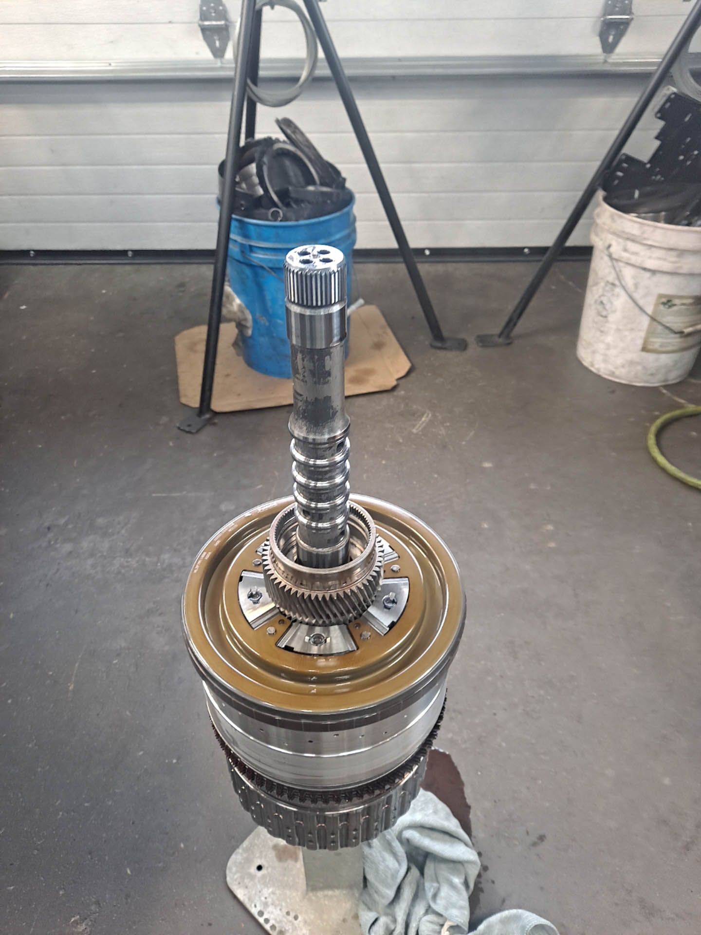 A large metal object is sitting on the floor in a garage.