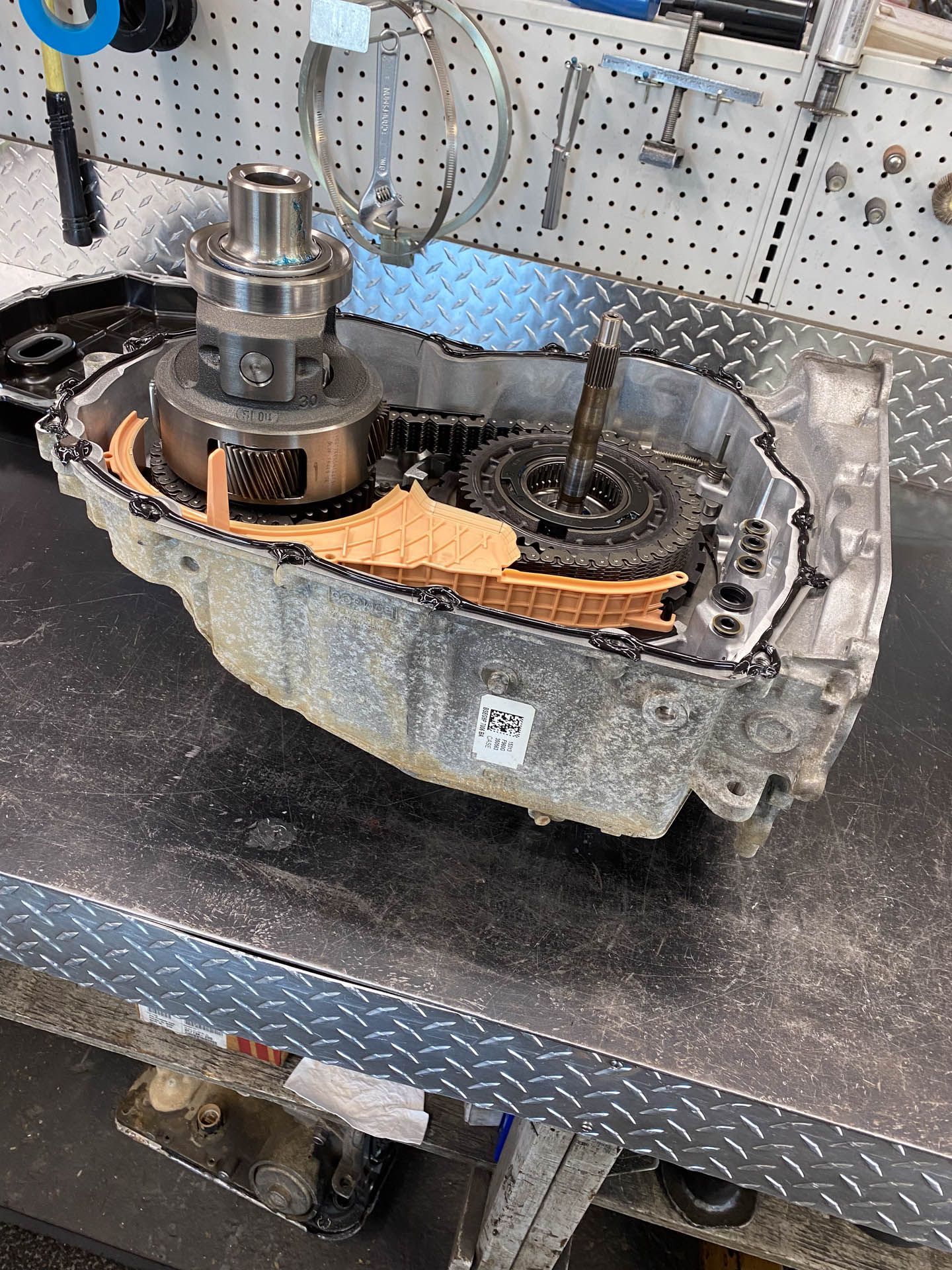 A piece of metal is sitting on top of a metal table.