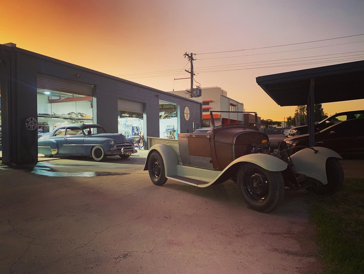An Old Car is Parked in Front of a Garage — Auto Craft Collective in Rockhampton, QLD